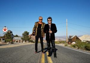 Graham Russell and Russell Hitchcock of Air Supply standing on lonely desert road