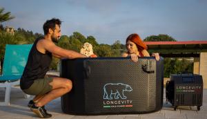 couple of athetes relaxing with the Longevity cold plunge tub