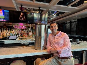 Paul Sadovsky with his countertop egg breaking machine at Cafe Americano in Miami Beach, FL