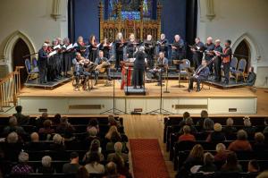 Crescendo Vocal Ensemble singers and period instruments on stage at Saint James Place in Great Barrington, MA