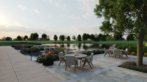 Tables and chairs on patio overlooking community lake at Trilogy Valor 55+ community