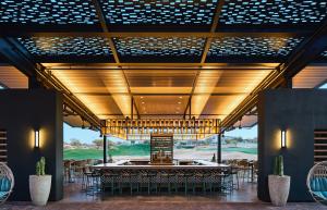 Photo of the newest bar at the Westin, Antidote with ambient lighting and a view of the award-winning golf course. Antidote is the Westin Kierland Resort's newest amenity: a social hub and bar perfect for any occasion.