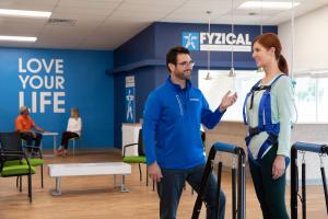 an image of a patient participating in physical therapy with a professional therapist