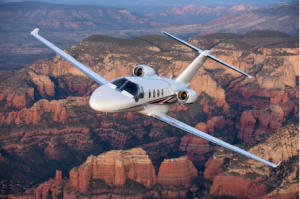 Citation M2 jet flying over mountains, courtesy of The Jet Agent