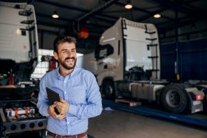 Truck repair shop owner reviewing a customer order inside the repair shop, ensuring efficient service and high-quality truck repairs. Enhancing customer satisfaction and workflow management for commercial truck maintenance.