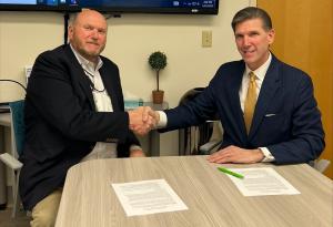 Curio MOU signing handshake - Hettel, McGinnis