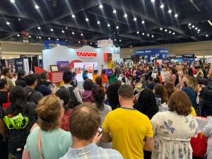 Onlookers at the Taiwan booth watch the dancers perform the Dance to the Waves of Wonder theme song