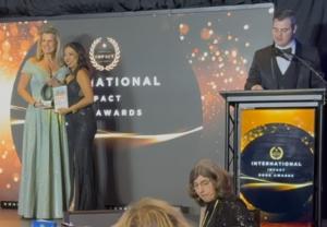 Dawn F. Landry Accepting International Impact Book Award from Founder, Nim Stant