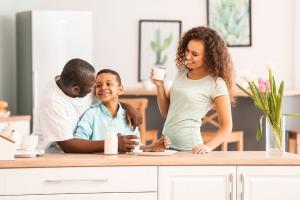 A family drinking milk together. Milk provides essential nutrients that can help your family stay healthy.