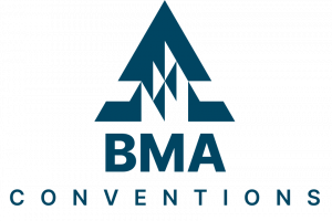 A large audience at the BMA Convention attentively listening to a speaker on stage. The event features industry professionals discussing medical innovations, healthcare policies, and best practices in a well-lit conference hall.