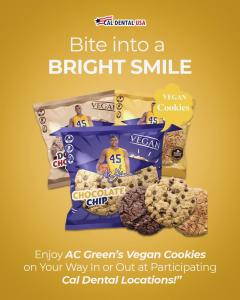 NBA Champion AC Green holding Ironman 45 Vegan Cookies in partnership with Cal Dental USA, promoting plant-based nutrition and wellness