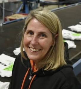 Lana Corsano in front of shirts going to dryer