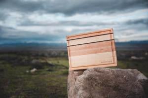 Maple and walnut inlay butcher block on rock overlooking countryside.