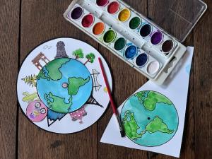 Children create a custom watercolor and paper globe spinner