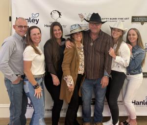 Honorary Chairs and their guests in front of the step & repeat banner