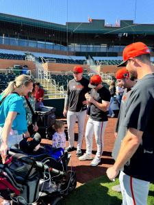 San Francisco Giants players signing baseballs for pediatric patients and families during a Team Select Home Care spring training event in Scottsdale.