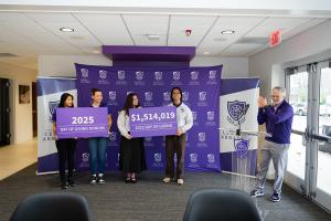 UCA President Houston Davis celebrates 2025 Day of Givling totals while students hold results cards at announcement ceremony.