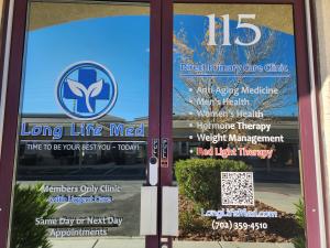 a close-up of Long Life Med's two front doors, showcasing their services, from Direct Primary Care with members only Urgent Care, Same Day or Next Day Appointments, and the Longevity Services like Anti-Aging Medicine, Men's Health, Women's Health, Hormone