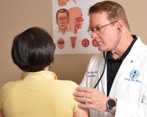 NP Linton examining a patient at Long Life Med