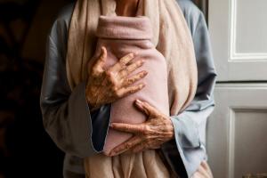 Hot water bottle being held