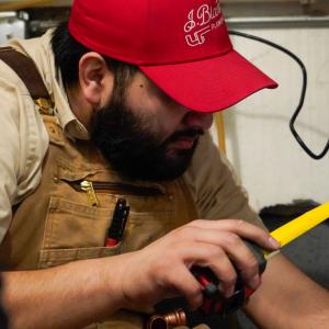 J. Blanton Plumbing technician on a service call, highlighting the company’s 24-hour plumbing services, drain cleaning expertise, and sewer drain clearing solutions in support of Special Olympics Illinois' Lake Michigan Plunge.