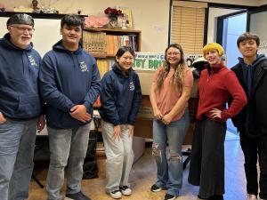 3 students from Robotics Team along with one team parent, representative from PACTL and Annamarie von Firley pose for photo with donated toys.