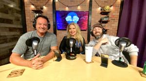 Photo of two men and a woman in a podcast studio