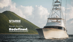 A luxury yacht on the ocean with a mountainous backdrop, showcasing the durability and finish achieved using Starke Yacht Surface Technologies products.