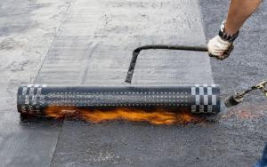 Torch down specialty roofing used to waterproof a multi-storey residential building.