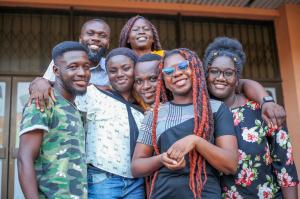 This picture shows a group of people posing close to each other and facing the camera