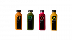 Four juice bottles from Town Center Cold Pressed are shown lined up in a row.