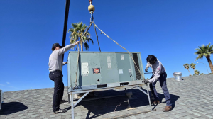an Image of Olive Air & Heating's Tech Team Professionally Installing an AC Unit on a roof for one of their customers in Gilbert.