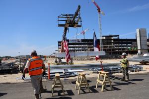 Forklift carrying a white beam