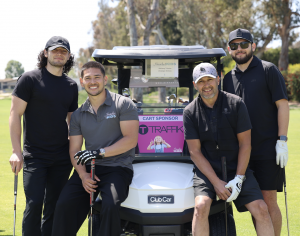 Cart Sponsor TRAFFIK, led by President & CEO Anthony Trimino (2nd from right) and sons, Niko, Christian, and Elijah, enjoying a break and a family photo with their sponsorship's namesake.
