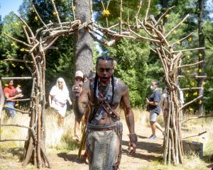 Andre Strongbearheart Gaines Jr. at the Arnold Arboretum during the 2022 MassQ Ball walking through nature portal installation