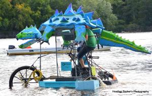 A sculpture of a crocodile cruising down the Merrimack River