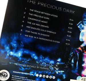 a black album cover with track list, and swirling colors