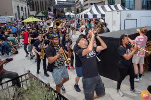 It's a parade of New Orleans jazz players entering the festival. Trumpets blaring, marching, celebrating the Jersey City Jazz Festival!