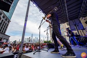 The scene of the event is magic. A giant stage with musicians playing with the New York skyline in the background!
