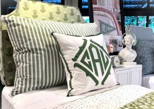 Details of dorm room bed headboard, huge Dutch pillows, and bedside table decor from Ballard Designs