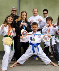 Gerry Blanck (center right) stands proudly with his award-winning students after the Palisades fire destroyed their beloved Pacific Palisades dojo. A fundraiser gala will be held May 17 at the Hilton Santa Monica to help rebuild the dojo and support youth martial arts.