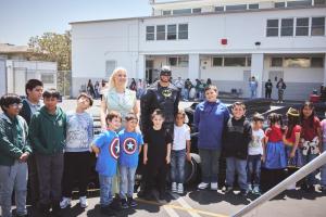 On a vibrant Tuesday morning, the playground at Our Lady of Guadalupe School in East L Hazel Ortega and Batman brought smiles and inspiration to the students of Our Lady of Guadalupe School during the Hero Initiative, standing proudly beside the Batmobile in the heart of the schoolyard—a day filled with imagination, empowerment, and fun.