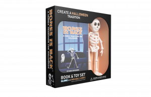 The book and toy are packaged in a display box—book on the left, standing toy on the right. Bones Is Back is a Halloween book and toy set featuring a glow-in-the-dark, poseable skeleton figure and a hardcover illustrated book.