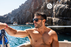 Handsome male influencer by a beach - Bamba Travel