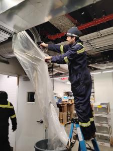 A Filta Kleen Hood Cleaning Specialist Cleaning a Commercial Air-Duct.