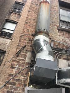 A Filta Kleen Hood Cleaning Specialist Cleaning a Commercial Air-Duct at a Local NYC Restaurant.