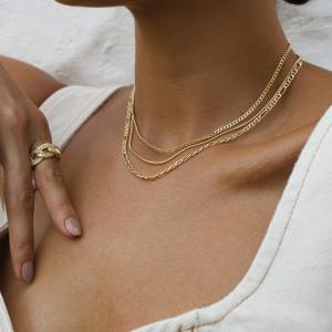 Close-up of layered waterproof necklaces by Velani Jewelry, featuring 18K gold-filled chains designed for sensitive skin and tropical climates.