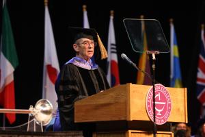 Larry Purnell speaks from a podium at Excelsior graduation in 2022.