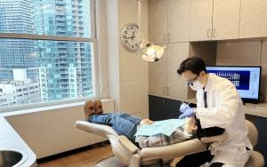 Seattle dentsit Dr. Harry Shin performing dental implants procedure at Moritis Shin Dentistry of Seattle