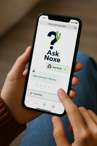 A person using the AskNoxe chatbot on a smartphone, displaying the AskNoxe logo and a conversation interface with a friendly greeting. The screen shows a message box and voice input icon, highlighting the platform’s clean, user-friendly design and real-ti